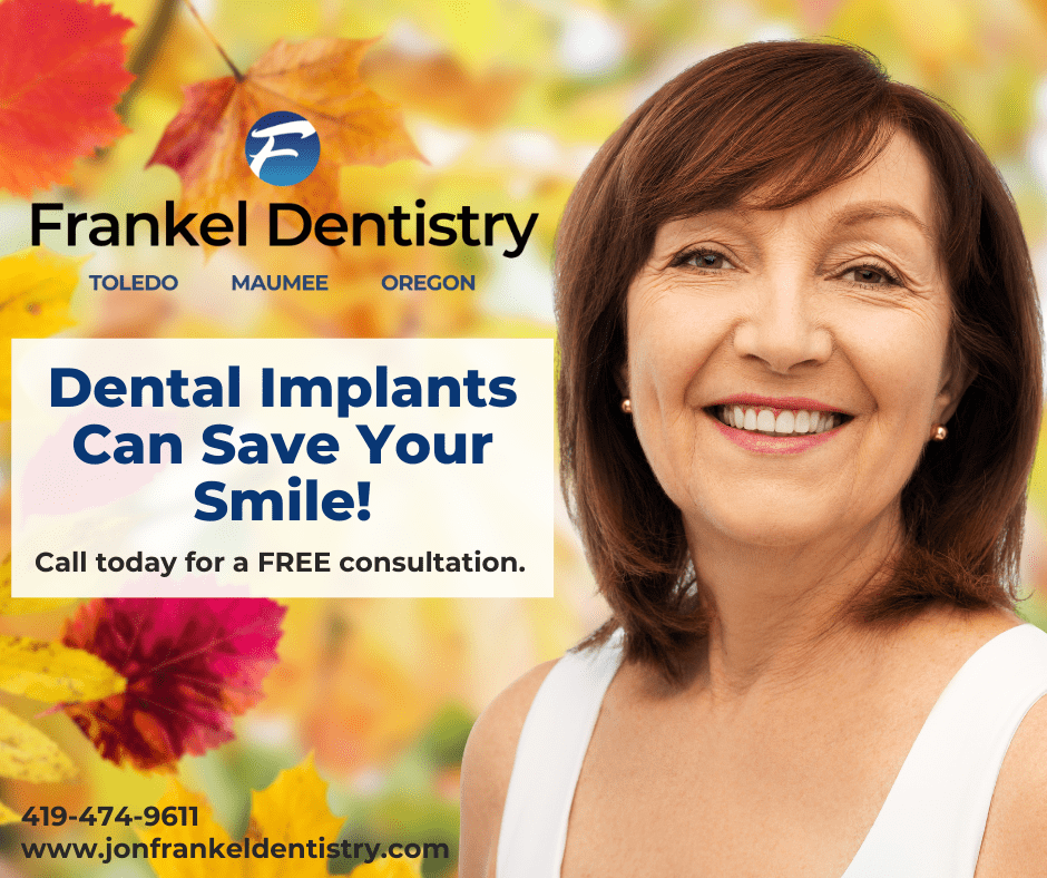 Smiling woman with fall leaves in the background with text saying "Dental Implants Can Save Your Smile" 